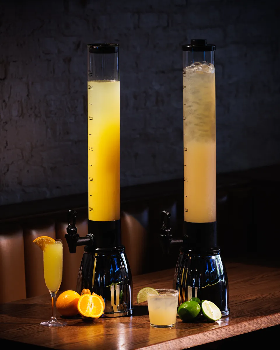 Self-serve mimosa towers on a brunch table