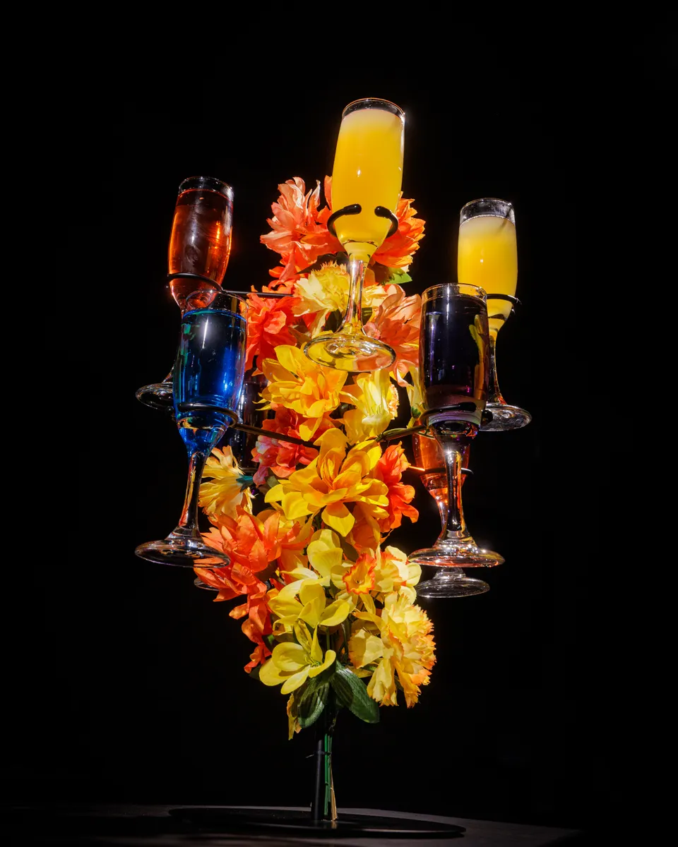 Mimosa tree with champagne flutes, flowers, and colorful shots
