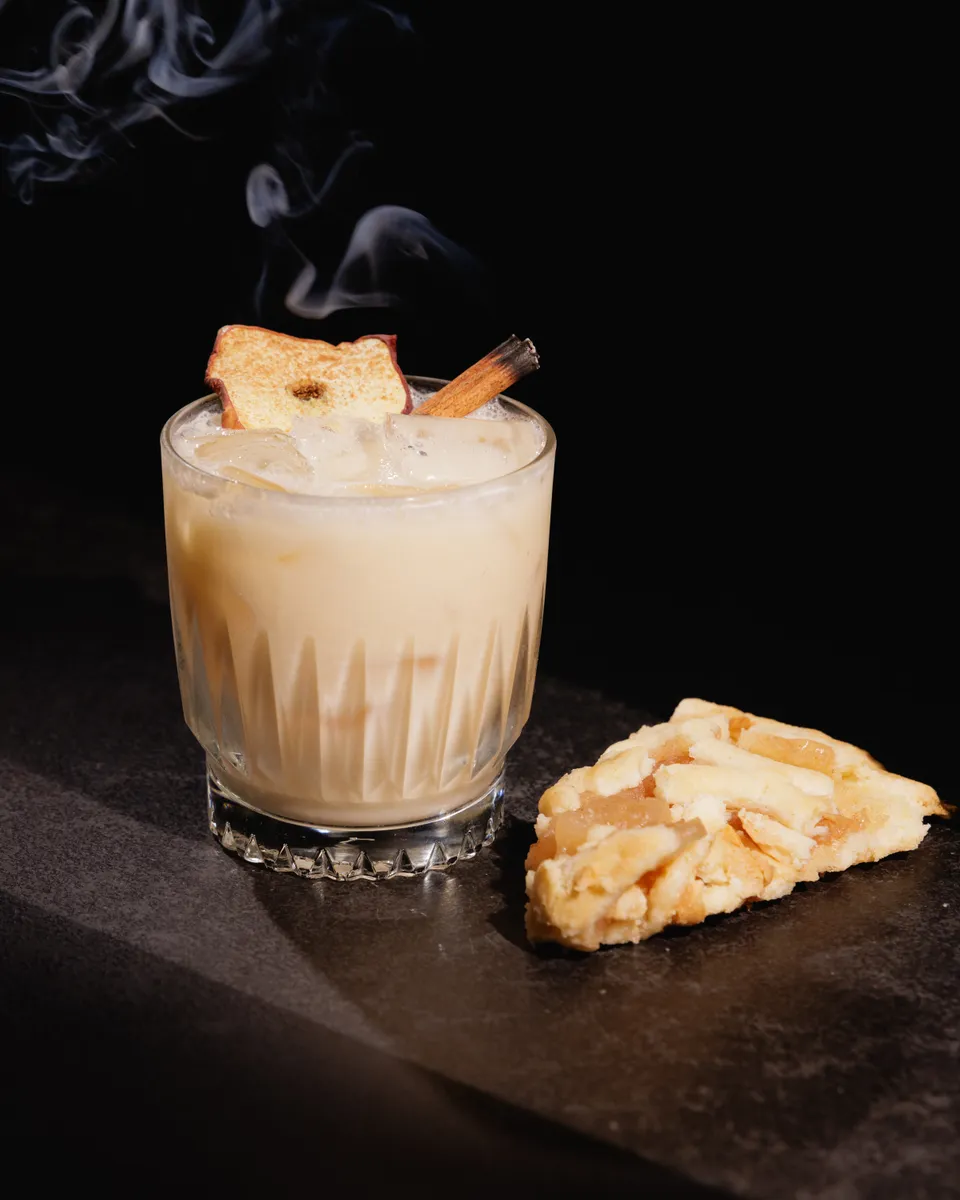Smoking cream cocktail with toasted garnish and a pastry